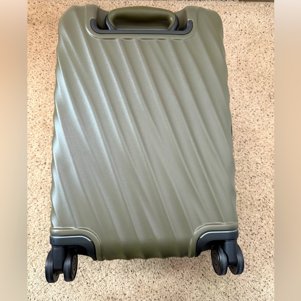 Tumi international expandable four wheeled carry-on. Never used.